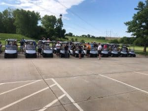 golfers in golf carts at MIB golf event